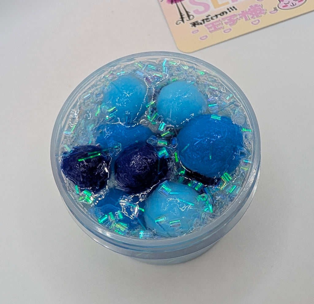 Lando - Clear PomPom slime with iridescent addins